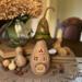 A mushroom house made from natural gourds. The original gourd stem on the top. A "Toad Stool Inn" house sign hangs on the side. 
